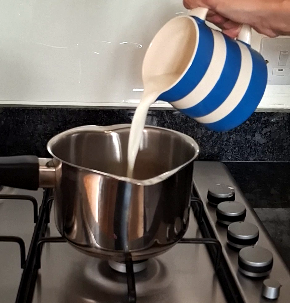 Pouring milk into saucepan